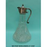 A cut glass decanter with plated mask spout mount,