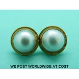 A pair of 18ct gold earrings set with a mabe pearl to each