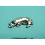 A cast hallmarked silver model of a pig lying down, London 2000 with millennium mark,