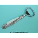A Georg Jensen white metal handled bottle opener,