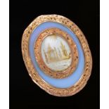 A Georgian plaque/ pendant with chased gold borders surrounding an opalised section with foiled