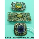Three white metal brooches set with various stones