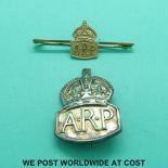 A 9ct gold ARP badge together with a hallmarked silver example.