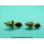 A pair of Roman yellow metal earrings set with garnets