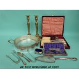 A cased 12-piece fish knife and fork set with bone handles, brass candlesticks,