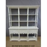 A painted three drawer dresser with shelves above,