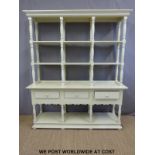 A painted three drawer dresser with shelves above,