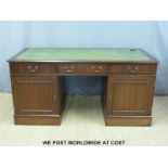 A leather inset twin pedestal desk (L161 x D76 x H78cm)