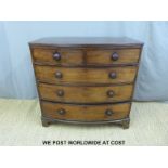 A 19th century bow front chest of two over three drawers with turned bun handles (W101 x D53 x