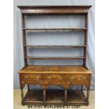 A Georgian oak dresser with plate rack above,