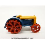 Dinky Toys diecast model Fordson N tractor with blue and yellow body and red wheels