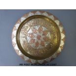 An Eastern inlaid copper and brass dish,