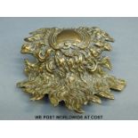 A brass sunburst design shaped plaque,