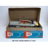 A collection of Trix, Hornby and other 00 gauge carriages, wagons, buildings and accessories,