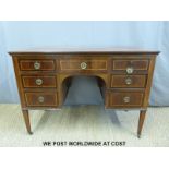 A late 19th / early 20th century desk with seven variously sized drawers,