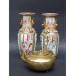 A pair of Chinese Canton famille rose vases decorated with court scenes and gilt dragons and with