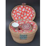 A Chinese tea set in fitted wicker travelling case