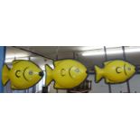 Three very large graduated illuminated fish,