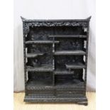 A Japanese heavily carved black lacquer bookcase/shelf unit with two drawers to base (H98 x W72 x