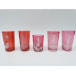 Five Mary Gregory cranberry glass drinking tumblers, all with enamel decoration,