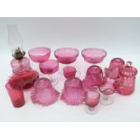 Eighteen cranberry glass lamps, shades, tazzas, plates etc,