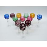 A set of 12 flash overlaid cut glass hock glasses with faceted octagonal stems and star cut bases,