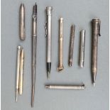 Eight propelling pencils, pencil holders and pens including hallmarked silver,
