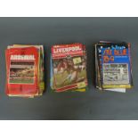 A collection of football programmes including Manchester United, Arsenal and Liverpool,