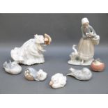 A collection of Lladro and Copenhagen figures