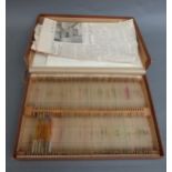 A boxed set of glass microscope slides with list of contents catalogued and numbered,