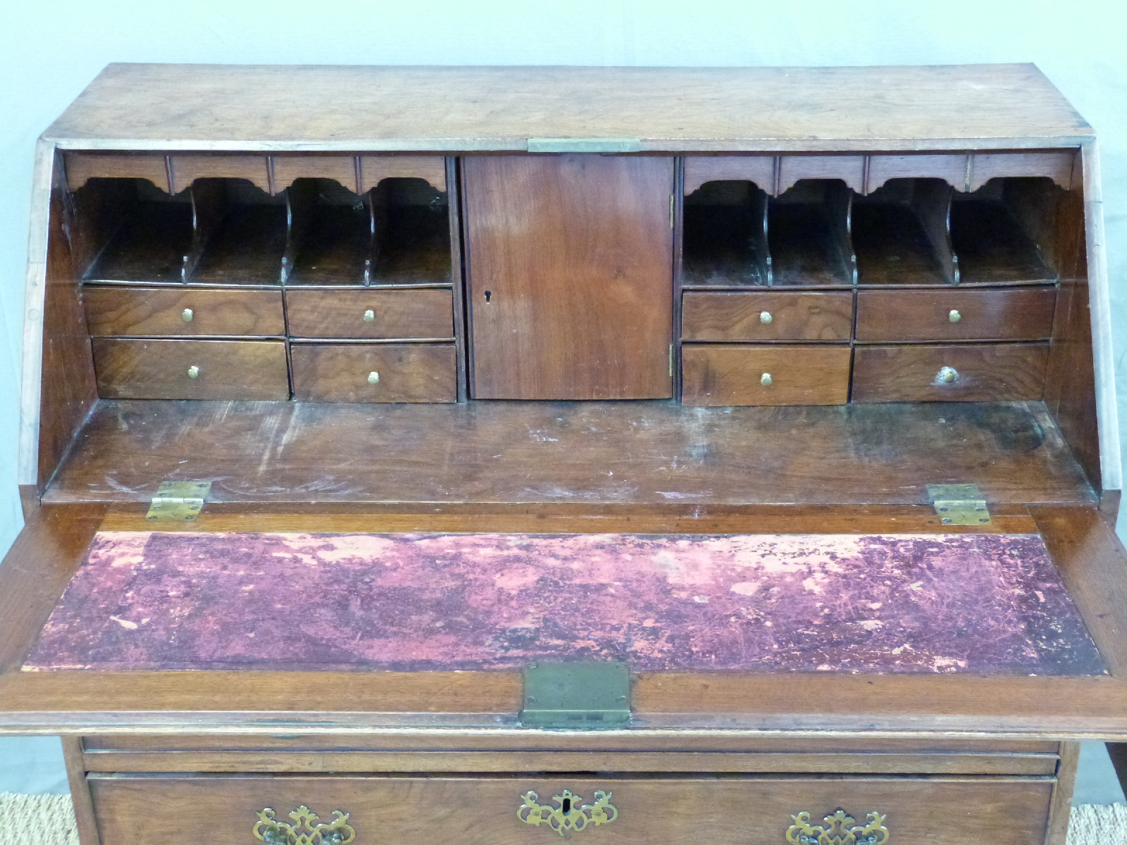A 19thC mahogany bureau with two over three graduated drawers and fitted interior raised on bracket