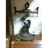 A cast iron figural seated dog umbrella/stick stand with semi circular drip tray in the