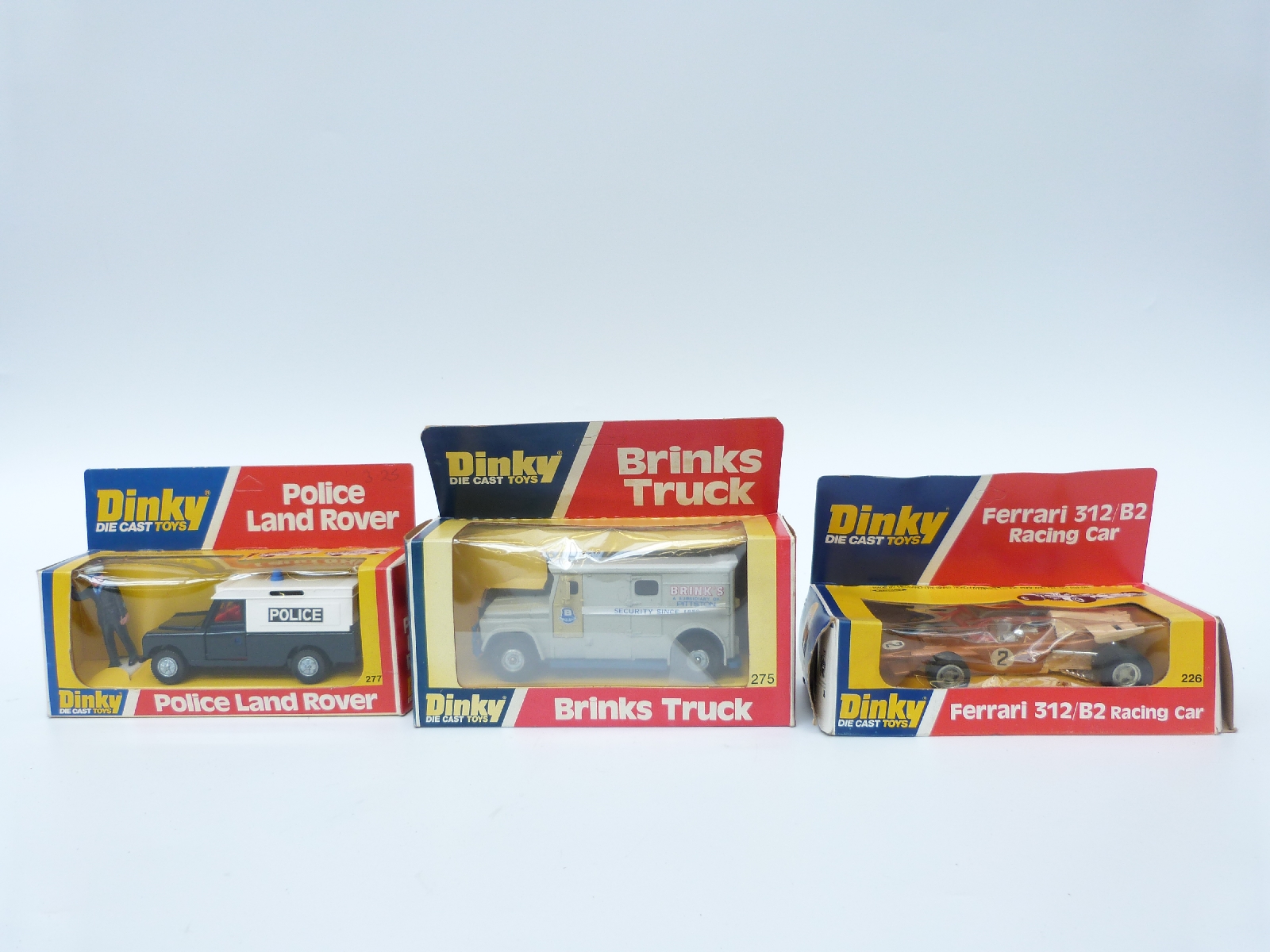 Three Dinky Toys diecast model vehicles comprising Ferrari 312/B2 Racing Car 226,