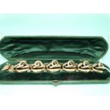 A Victorian yellow metal bracelet of knotted design, in original fitted box (41.