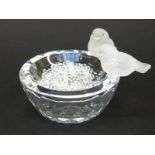 Swarovski bird bath featuring two frosted glass birds with crystal eyes on the side of a clear cut