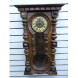 A late 19thC regulator wall clock in carved columned case,