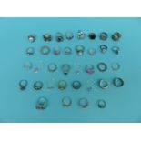 A collection of 37 silver/white metal rings including pearl, topaz,