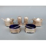 Two George V hallmarked silver three-piece condiment sets comprising mustard pots,