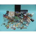 A large collection of costume jewellery to include brooches, necklaces,