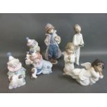 A collection of boxed Lladro child figures including clowns & Little Fireman