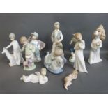 A collection of Nao child figures including babies, shoeshine, boy on phone with puppy,