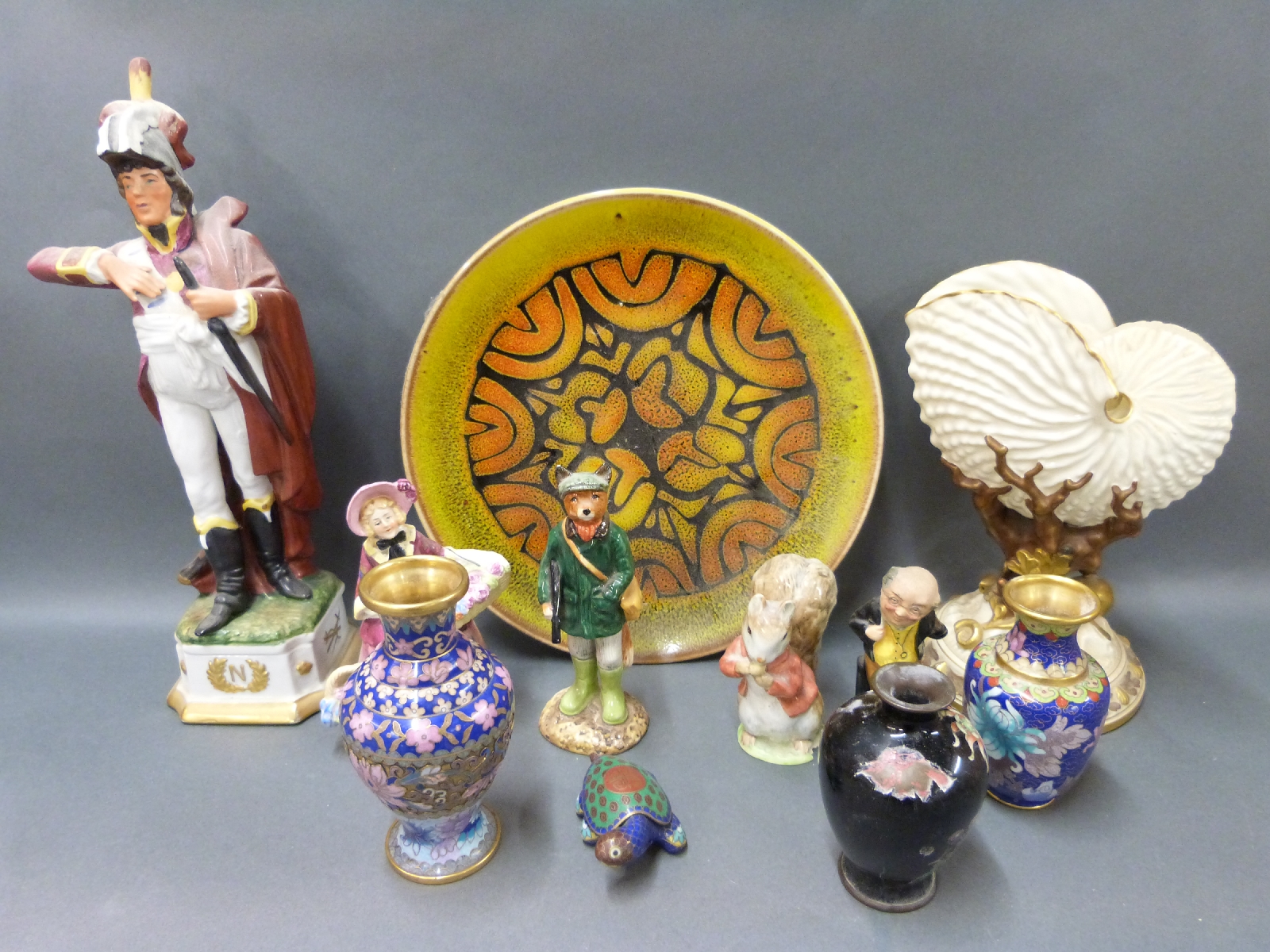 A collection of ceramics including Royal Worcester nautilus shell, Poole plate, Beswick,