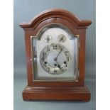A three train Junghans mantel clock with silvered Arabic dial,