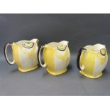 A set of three graduated Art Deco jugs,