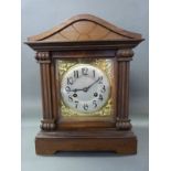 A c1900 architectural style mantel clock with silvered Arabic dial,