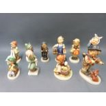 Ten Goebel Hummel figures including boy with ladder,