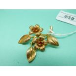 A 9ct gold brooch in the form of two flowers set with citrines, 9.