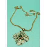 A yellow metal pendant marked 14k in the form of a stylised cross set with a green cabochon on a