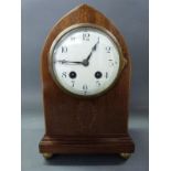 An Edwardian inlaid mahogany mitre shaped mantel clock with laurel leaf inlaid decoration,