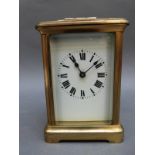 Brass corniche style French carriage clock with enamelled dial with bold Roman numerals with